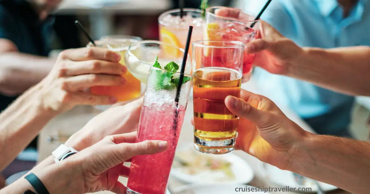 Group of friends drinking holding out their alcoholic drinks