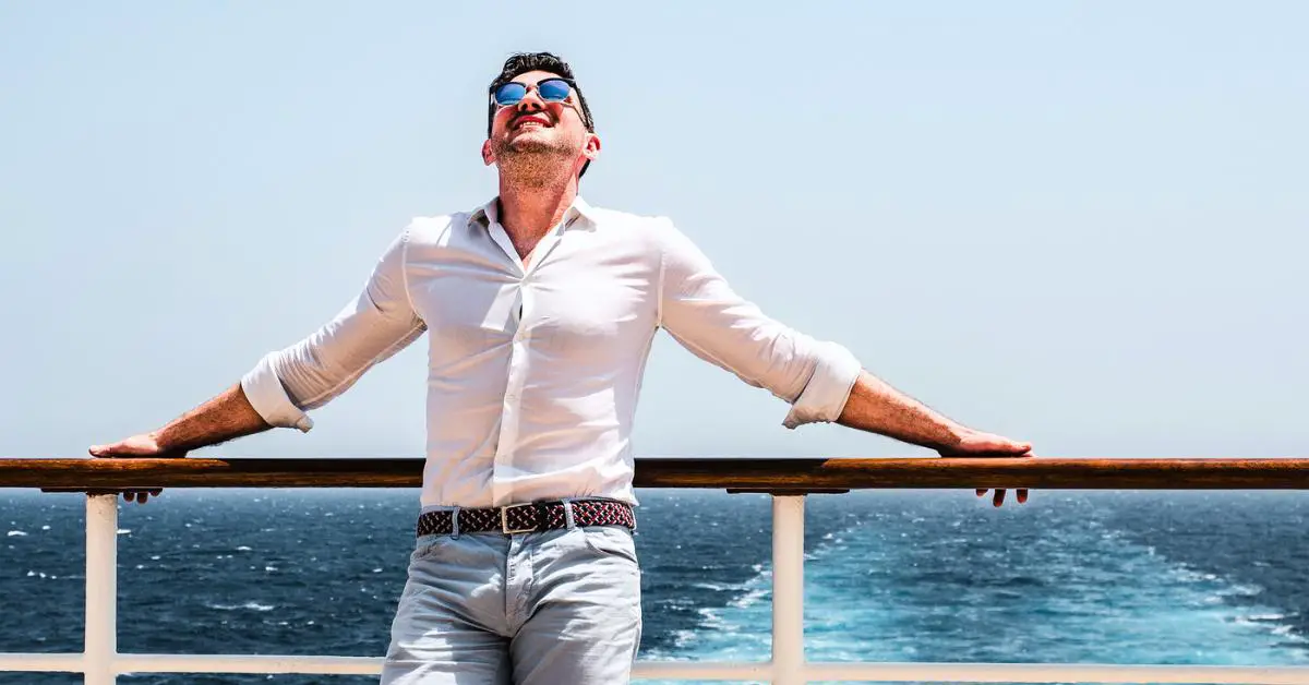 Single guy at the aft of cruise ship with propeller wash in background