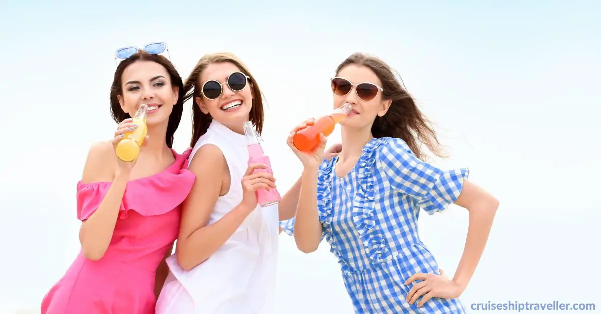 3 young women on cruise vacation drinking alcohol from bottles