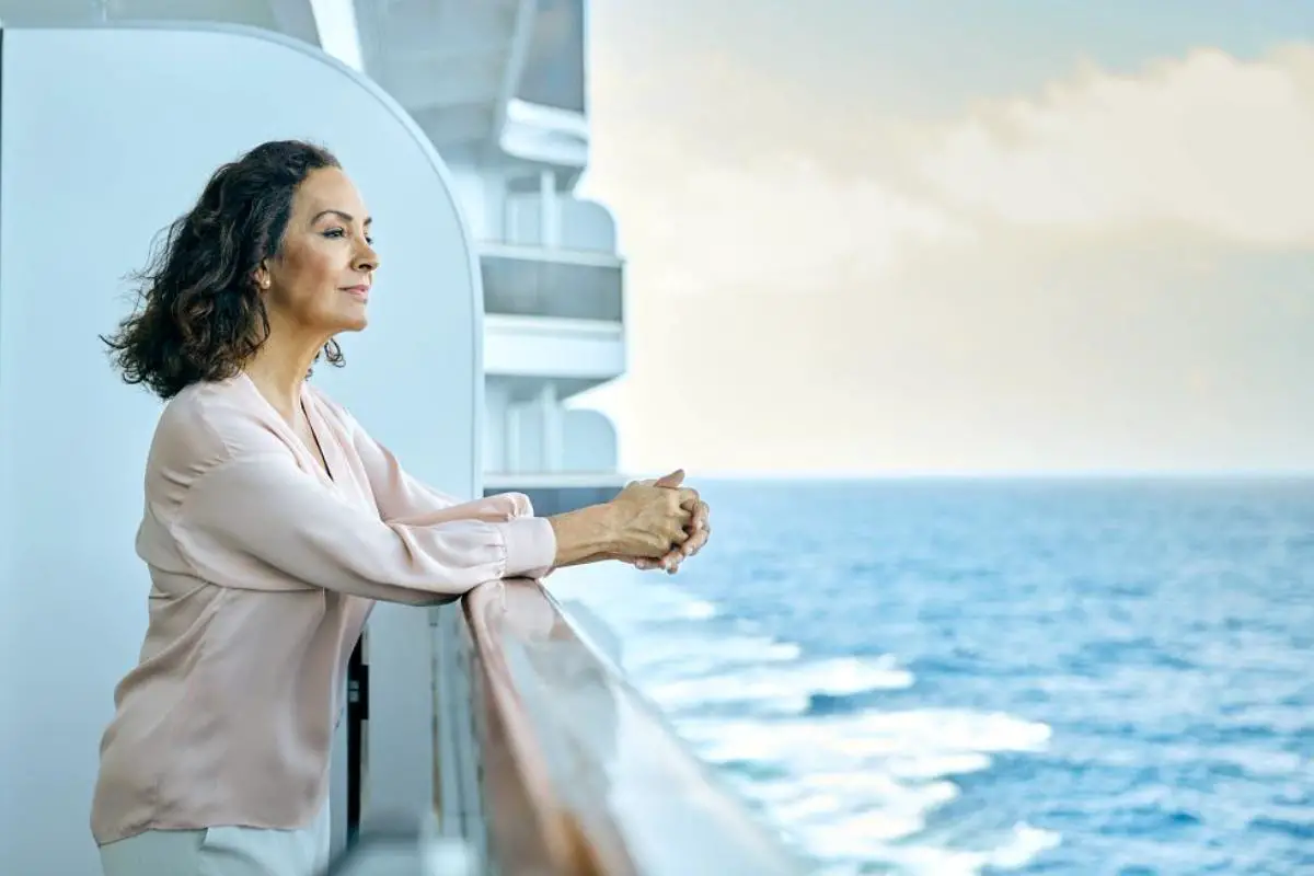 Single senior woman overlooking Neptune  suite balcony Holland America Nieuw Statendam