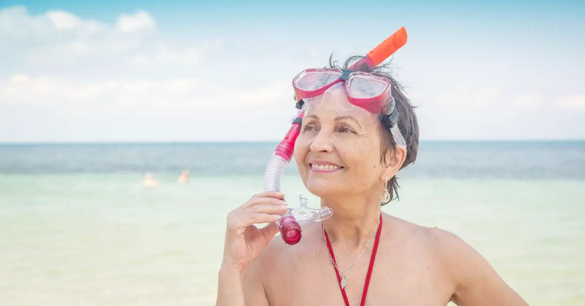 Older single woman snorkling on cruise excursion