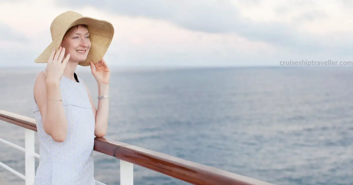 single woman in 30s on cruise ship deck overlooking sea