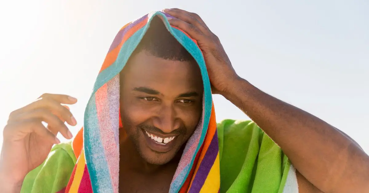 Man drying hair with towel
