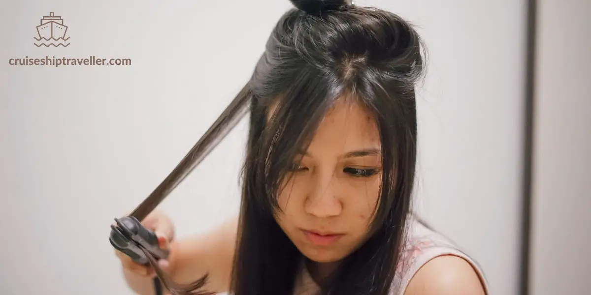Woman using hair straighteners